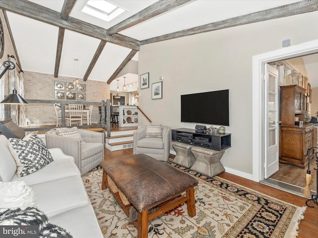 living room with brick wall, wood-type flooring, and lofted ceiling with beams