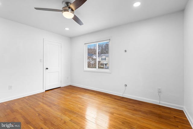 unfurnished room with ceiling fan and wood-type flooring