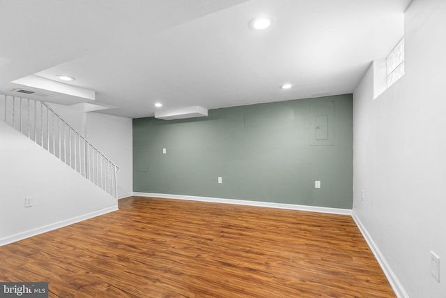 basement with hardwood / wood-style floors