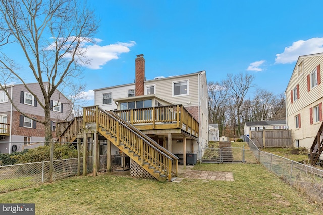 rear view of property with a wooden deck, a yard, and central AC unit