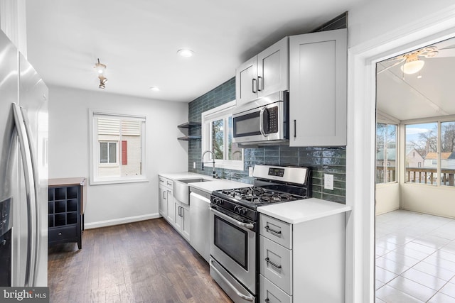 kitchen featuring sink, decorative backsplash, plenty of natural light, and stainless steel appliances