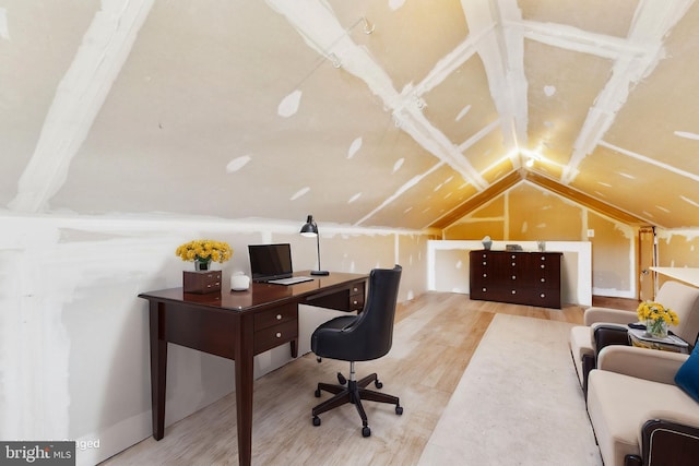 office with lofted ceiling and light wood-type flooring