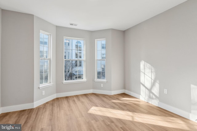 empty room with light hardwood / wood-style flooring