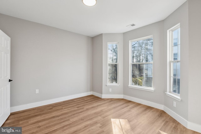 spare room with light hardwood / wood-style flooring