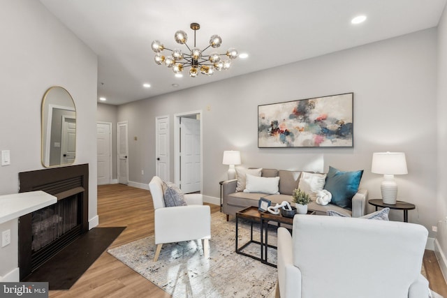 living room with a notable chandelier and wood-type flooring