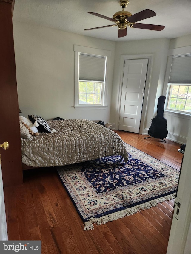 bedroom with a ceiling fan and wood finished floors