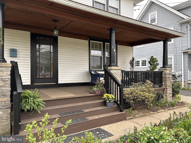 view of exterior entry featuring covered porch