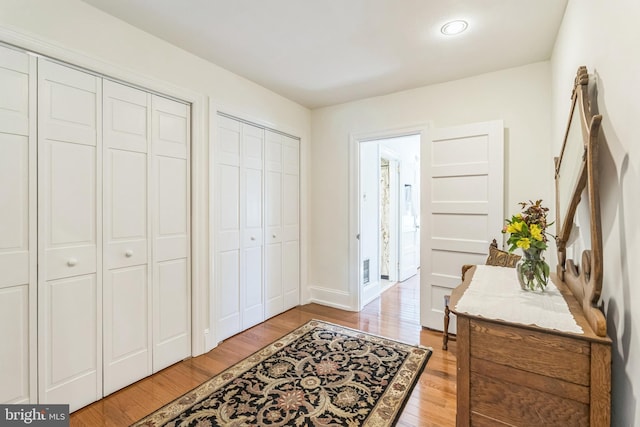 foyer with baseboards and light wood-type flooring