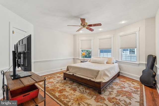 bedroom with a ceiling fan, baseboards, recessed lighting, and wood finished floors