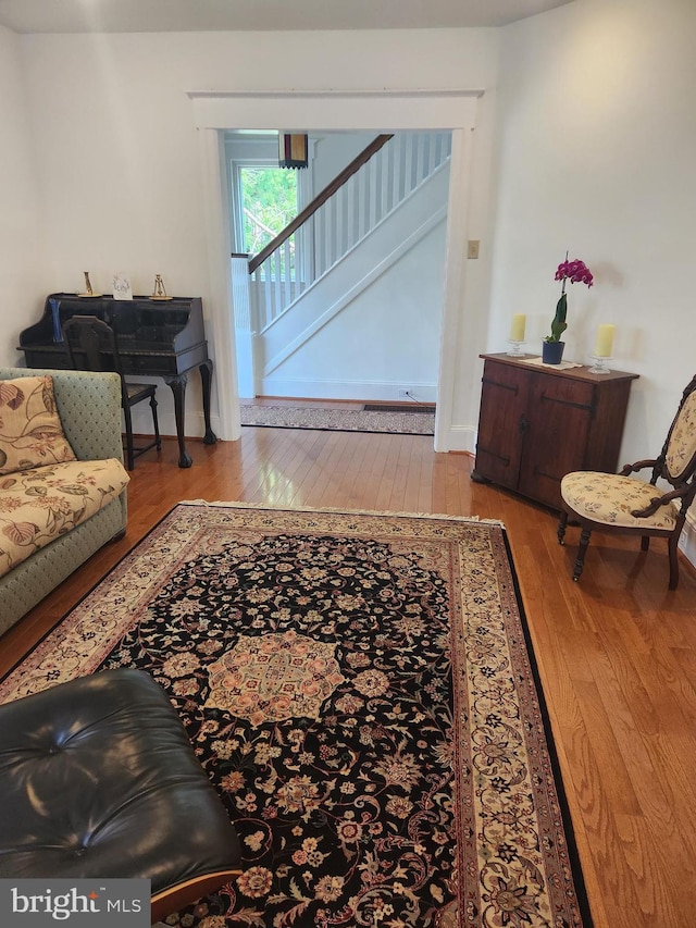 living room featuring wood-type flooring and stairs