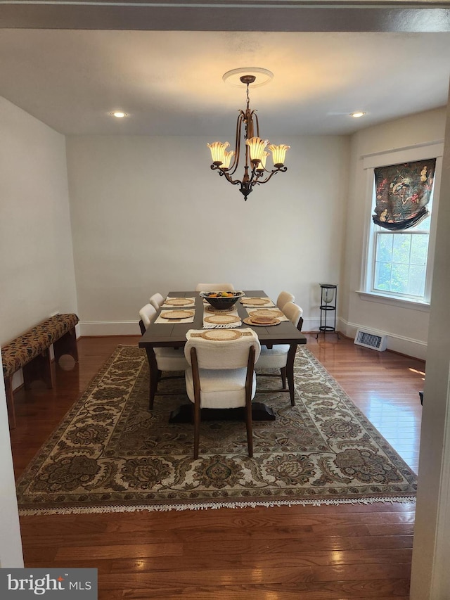 dining room with visible vents, wood finished floors, baseboards, a chandelier, and recessed lighting