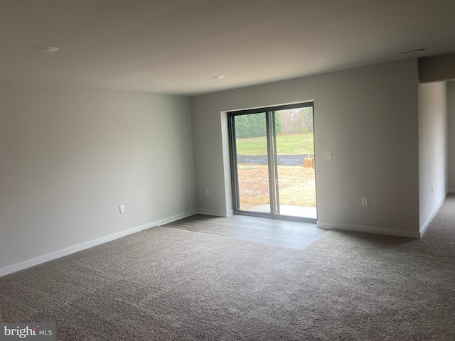 spare room featuring light colored carpet