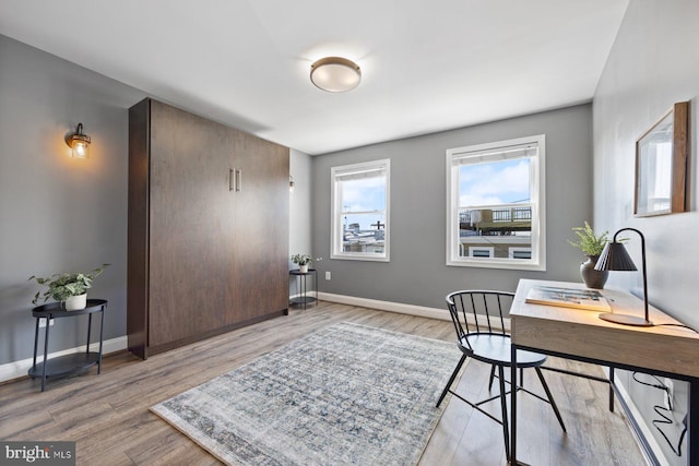 office area featuring baseboards and wood finished floors