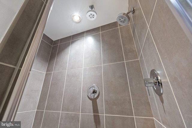 interior details featuring tiled shower