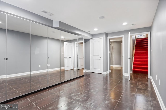 unfurnished bedroom with tile patterned floors, baseboards, visible vents, and recessed lighting