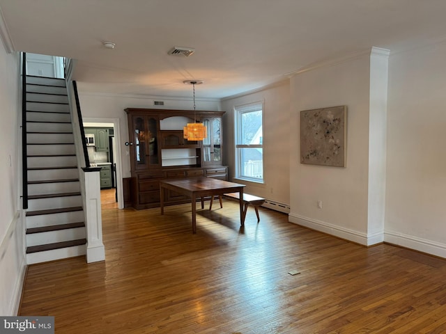 dining room featuring dark wood-type flooring and ornamental molding