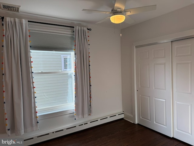 interior space featuring hardwood / wood-style flooring, a baseboard radiator, and ceiling fan