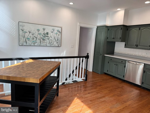 kitchen featuring dark hardwood / wood-style flooring, decorative backsplash, a center island, and dishwasher