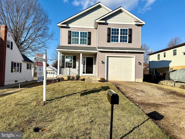 view of front of home featuring a garage, a front yard, and covered porch