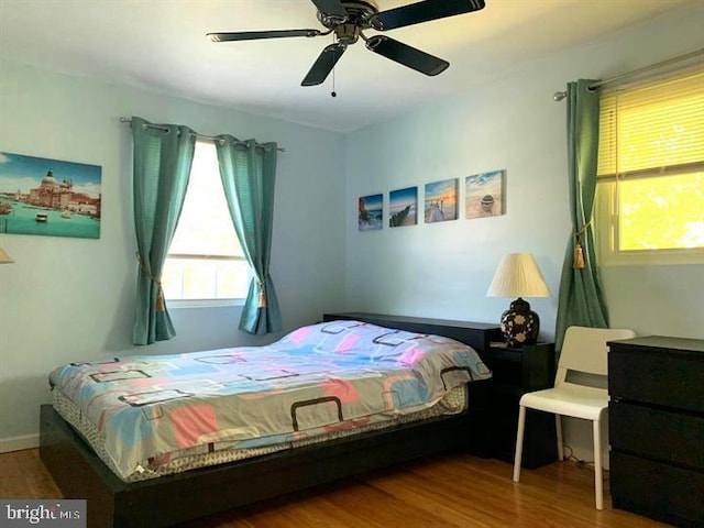 bedroom with wood-type flooring and ceiling fan