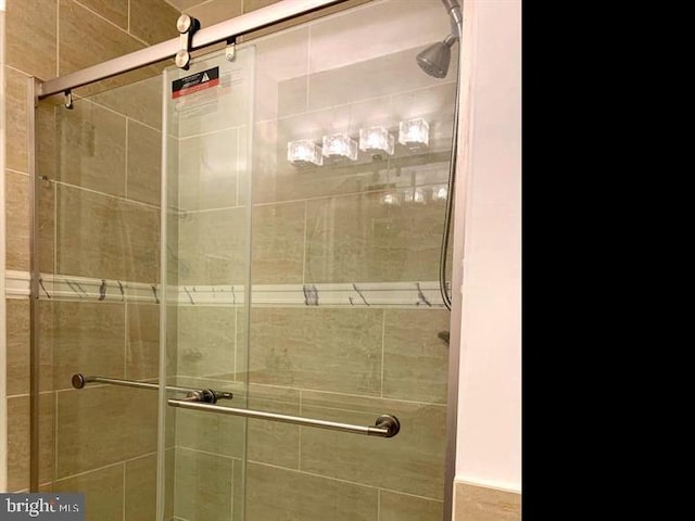 bathroom featuring a shower with door