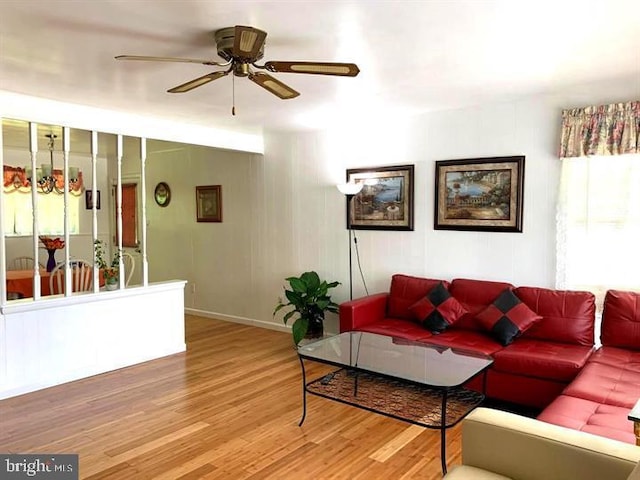 living room with hardwood / wood-style floors and ceiling fan