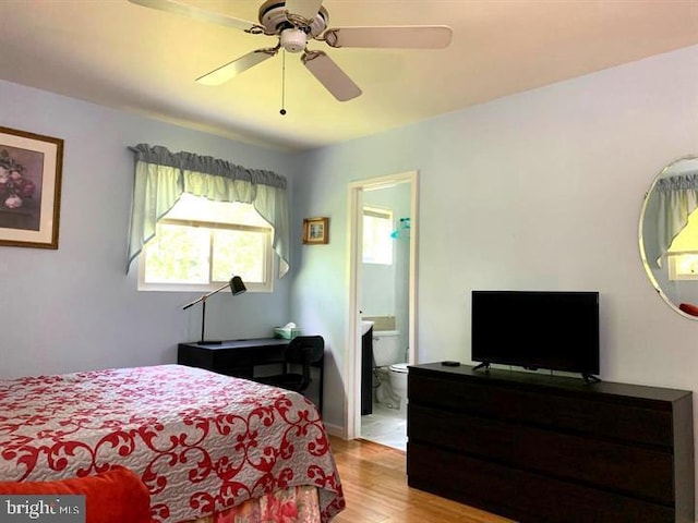 bedroom featuring ensuite bathroom, ceiling fan, and light hardwood / wood-style flooring