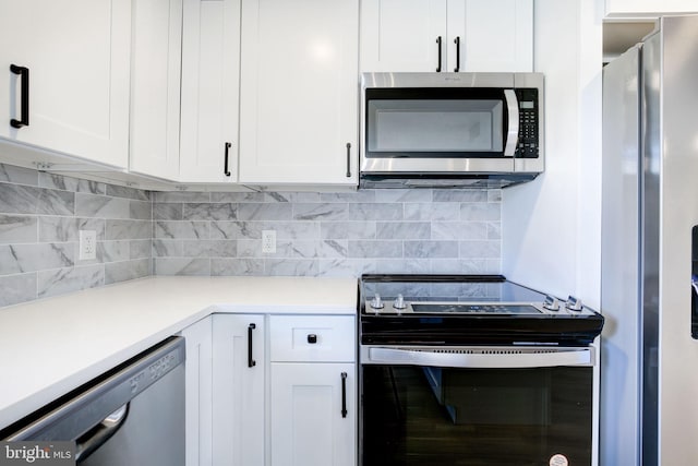 kitchen with white cabinetry, appliances with stainless steel finishes, and backsplash