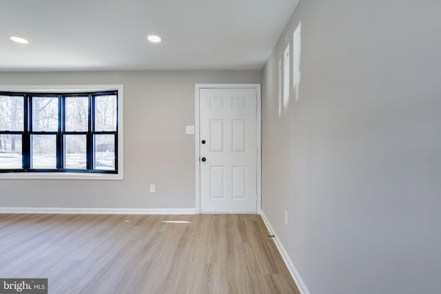 unfurnished room with light hardwood / wood-style floors