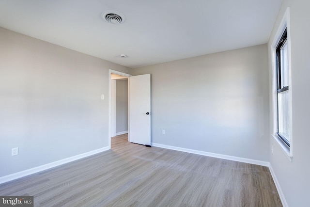 unfurnished room with light hardwood / wood-style floors