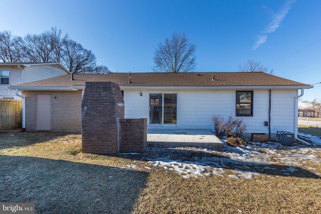 rear view of property featuring a patio area and a lawn