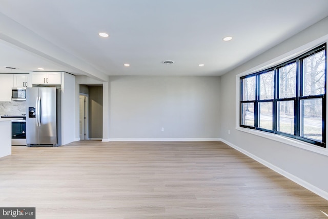 unfurnished living room with light hardwood / wood-style flooring