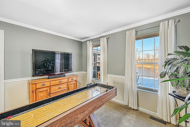 game room with ornamental molding and light colored carpet