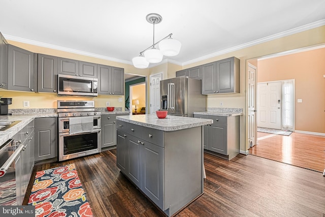 kitchen featuring gray cabinets, stainless steel appliances, and a kitchen island