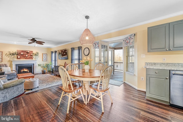 dining space featuring ceiling fan, ornamental molding, and dark hardwood / wood-style flooring