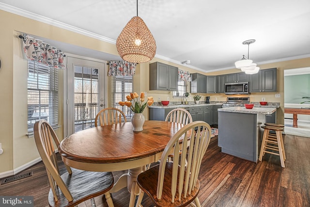 dining room with crown molding and dark hardwood / wood-style floors