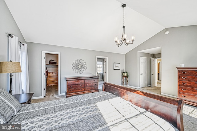 bedroom with lofted ceiling, carpet floors, a chandelier, a walk in closet, and a closet