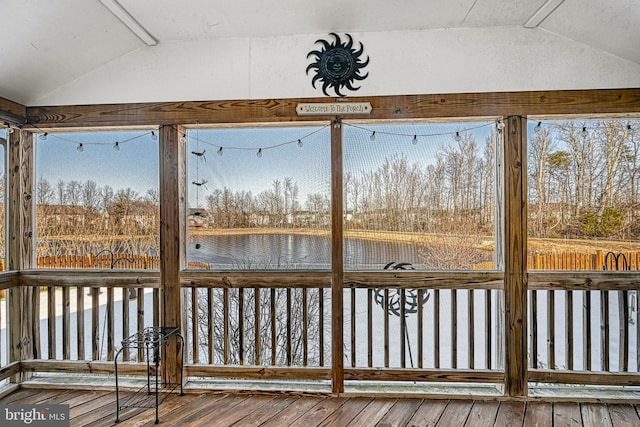 unfurnished sunroom featuring a water view and lofted ceiling