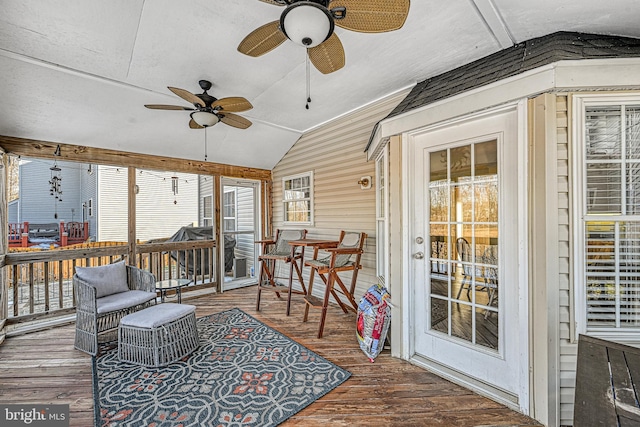 sunroom / solarium featuring ceiling fan and vaulted ceiling