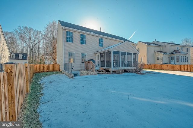 rear view of property featuring a sunroom