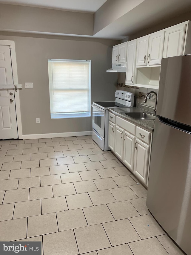 kitchen featuring white cabinetry, sink, stainless steel refrigerator, and electric stove