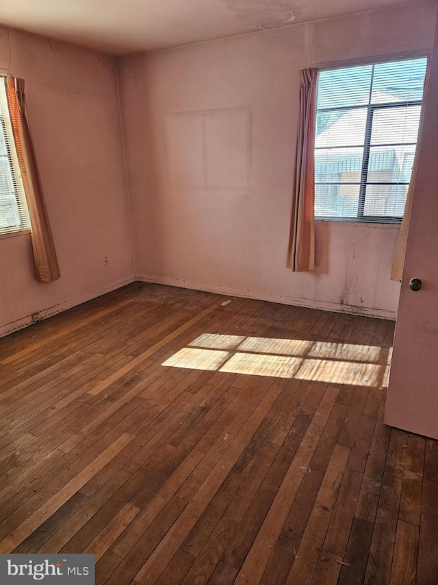 spare room featuring dark hardwood / wood-style flooring