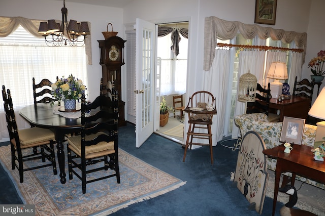 carpeted dining space featuring a notable chandelier