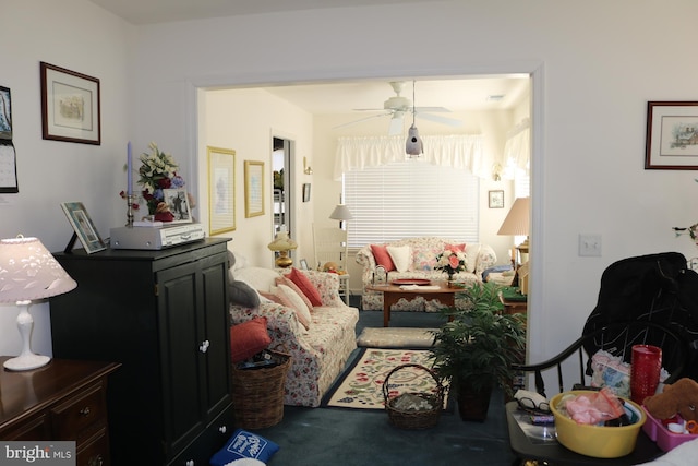 living room featuring ceiling fan and carpet