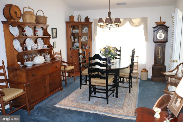 carpeted dining room featuring plenty of natural light and a notable chandelier