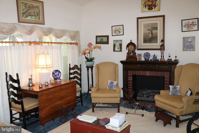 living area with a brick fireplace