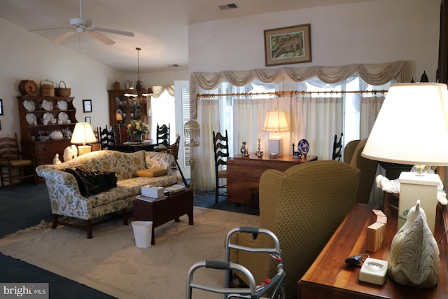 living room featuring lofted ceiling and ceiling fan with notable chandelier