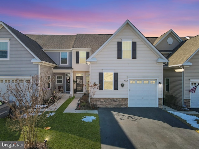 view of front of home featuring a yard and a garage