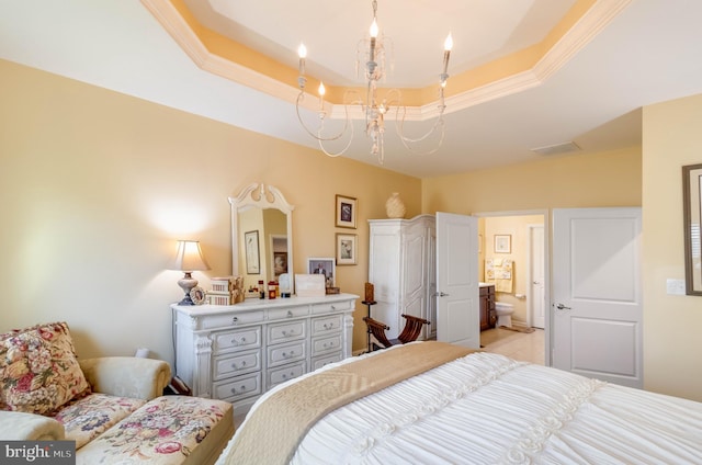 bedroom featuring ornamental molding, ensuite bathroom, a chandelier, and a tray ceiling