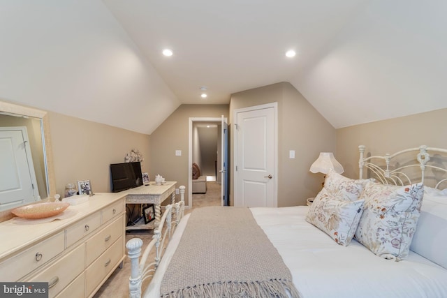 carpeted bedroom with vaulted ceiling